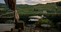 a table and chairs on a patio with a view